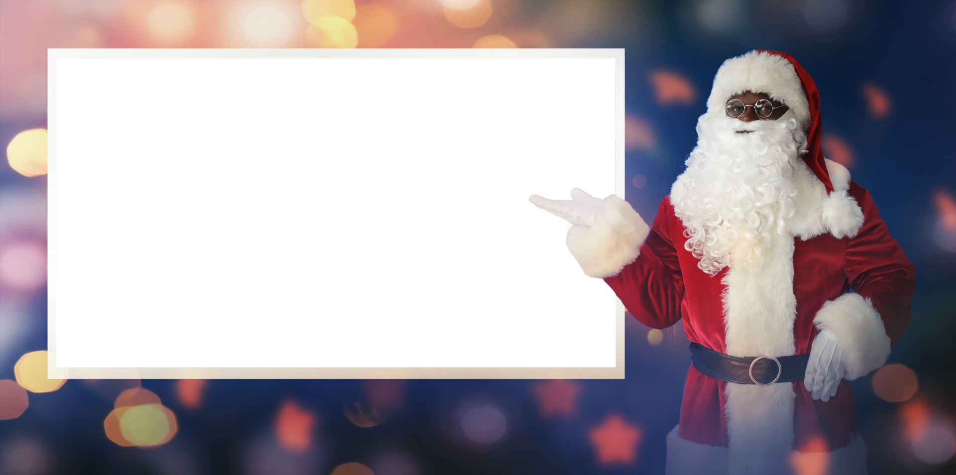 Santa standing with a background of bokeh lights pointing to a large canvas